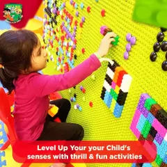 A young child engages with our large, interactive peg wall. This activity is great for developing fine motor skills and creativity in a fun, hands-on way.