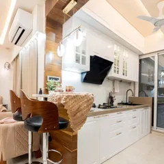 We designed this open-concept kitchen to be the heart of the home. The classic white cabinetry and a warm wooden breakfast bar create a welcoming space for cooking, conversation, and connection with the living area.