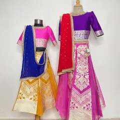 A back view of our custom sister lehengas, showing the delicate tie-up details and rich fabric. We ensure every angle is perfect for those candid wedding photos.