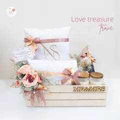 A treasure trove of love for the new Mr. & Mrs. This wooden crate hamper is filled with personalized towels, scented candles, and other keepsakes to help the couple begin their new life together in style.