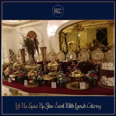 A lavish buffet table against a backdrop of gold-mirrored walls. The setup is dense with ornate brass serving dishes, candelabras, and floral arrangements, perfect for a grand, royal-themed wedding.