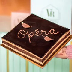 Our take on the French Opera cake. It has layers of almond sponge, coffee buttercream, and chocolate ganache. Every bite is a perfect foodgasm.