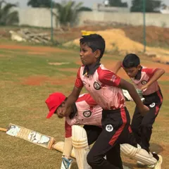 Young batters practice running between the wickets during a league match. We train our players on all aspects of the game, including smart and aggressive running.
