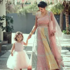 A precious moment between a mother and her daughter, the bride, as they walk hand-in-hand during the wedding festivities.
