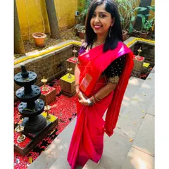 A gorgeous client from Australia wearing a custom hand-embroidered silk velvet blouse in a deep navy blue. The rich fabric and gold embroidery create a beautiful contrast with her pink saree.