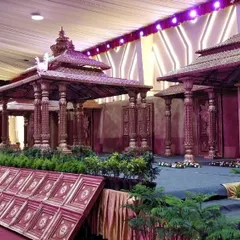 An expansive, multi-tiered stage setup designed to resemble a traditional temple complex. This vintage style decor creates a timeless and immersive experience for the wedding celebration.