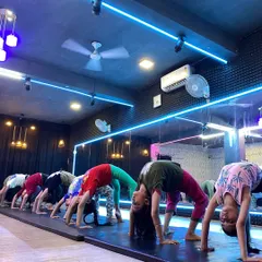 Our students work together on their backbends. Practicing in a group helps with motivation and allows our instructors to provide form corrections to the entire class.