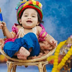 Our 'Bal Gopal' theme captures the playful spirit of little Krishna. This smiling baby, dressed in colorful attire with a peacock feather, perfectly embodies the divine mischief of Janmashtami.