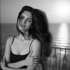 Captured on a balcony with the sea in the background. This unedited black and white photo has a beautiful, windswept feel, showcasing the power of a simple setup and natural environment.