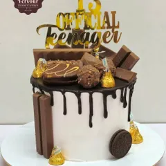 Another version of my popular chocolate overloaded cake, this one for a 13th birthday. It's a chocolate mousse cake with a white cream base, chocolate drip, and plenty of chocolate treats on top.