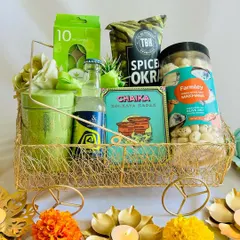 Our green-themed Diwali hamper is a celebration of nature and festivity. It includes a curated selection of healthy snacks like spiced okra and roasted makhana, along with scented candles and a refreshing drink.
