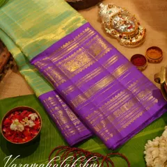 A vintage Kanjivaram tissue saree in light green and purple, a beautiful and unique choice for the Varamahalakshmi festival.