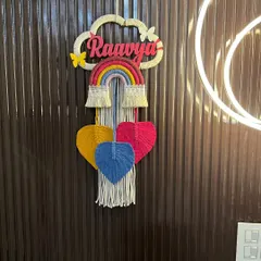 This 'Raavya' nameplate is a perfect example of my classic rainbow and cloud design. It features colorful hanging hearts and delicate butterfly accents for an extra touch of whimsy.
