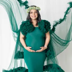 The emerald green gown with its long, flowing tulle cape is a client favorite. It creates a beautiful, ethereal effect that looks incredible in photos, especially when we add a little air from a fan.