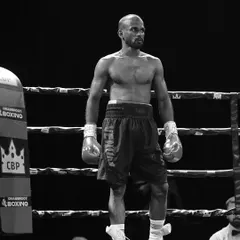 The calm determination of a fighter, standing alone in the ring, ready for the battle ahead.
