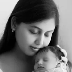 A serene black and white close-up of a mother and her newborn. This intimate portrait beautifully captures the quiet, loving bond between them.