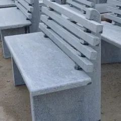 A modern-style garden bench with a slatted backrest, made entirely from natural stone. It is extremely durable and weather-resistant.