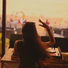 Lost in the music as the sun goes down. My silhouette against the golden sky, with my hair catching the ocean wind.