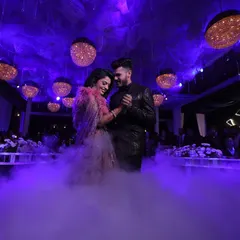 The first dance is a magical moment. I use theatrical elements like low-lying fog and dramatic purple uplighting to create a dreamy, cloud-like effect for the couple's special performance.