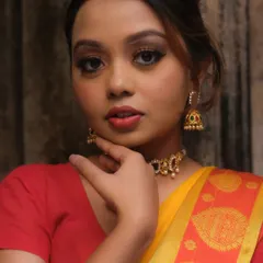 A portrait showcasing a classic makeup look with a defined brown smokey eye and neutral lip color. This versatile style works beautifully for many different traditional events and outfits.