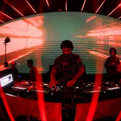 Mixing under the red lights. The atmosphere of the club is a huge inspiration, and I often find myself lost in the process of building a set.