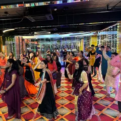 A wide shot of the dance floor during a Garba workshop. I can handle large groups, ensuring everyone learns the steps and is part of a cohesive, impressive performance.