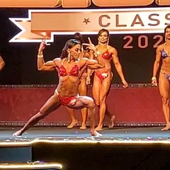 Executing a mandatory pose during a competition. I will guide you through every transition and pose to make sure your stage routine is flawless and impactful.