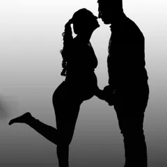 A playful and romantic silhouette of a couple about to kiss. This style is perfect for capturing the intimate connection and joy between partners in a timeless, artistic format.