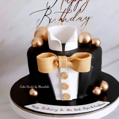 For the perfect gentleman. This tuxedo cake is sharp and stylish, with a crisp white shirt, a black jacket, and a golden bow tie and buttons.