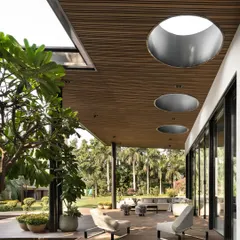 The covered deck is an essential part of the design, creating a seamless transition from the lounge to the outdoors. I incorporated large, circular skylights into the timber ceiling to draw in natural light and create playful shadows throughout the day.