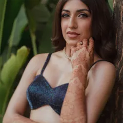 A closer look at Sheena's sangeet glam. The focus is on her sparkling eyes, achieved with soft, shimmering tones and a clean wing. It’s a look that feels dramatic yet lightweight, designed to catch the light as she dances the night away.