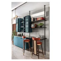 A custom-designed bar unit in a striking teal finish, with integrated racks to display the client's collection of antique radios and curios. This piece adds immense character and serves as a social hub.