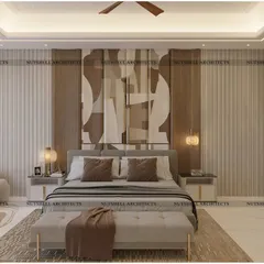 Art and elegance define this master bedroom. The statement headboard features a bookmatched veneer, where the natural wood grain creates a beautiful symmetrical pattern. On the right, wardrobe shutters are adorned with embroidered fabric for a touch of artisanal luxury.