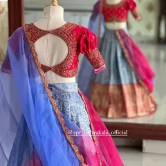 The back of the kids' lehenga, showing the blouse's cute circular cutout and the reflection in the mirror.