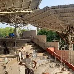 The steel superstructure for the bamboo parasols being erected at the TAPMI Centre. This image shows the engineered skeleton that supports the organic, crafted skin.