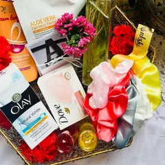 This self-care hamper is perfect for a bridesmaid, a friend, or even yourself. It’s packed with branded goodies like Olay cream, Dove soap, and L'Oréal shampoo, plus handmade touches like scented candles, scrunchies, and polaroids.