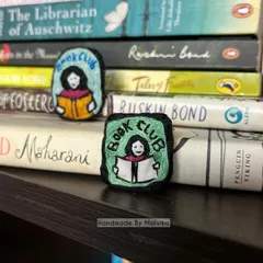 As a book lover myself, I had to create something for my fellow readers. I've placed these 'Book Club' badges right where they belong, among some of my favorite stories. It’s the perfect embroidered pin to add a literary touch to your jacket or tote bag.