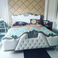 This classic tufted headboard and bed frame showcases my upholstery skills. I apply the same precision and detail to creating custom upholstered wall panels for high-end home theatres.