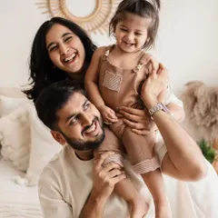 A perfect family moment, full of laughter and joy. Getting toddlers on dad's shoulders is always a great way to get genuine smiles from everyone.