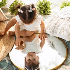Who's that I see? Using a mirror outdoors creates such a magical and curious moment for a child's portrait.