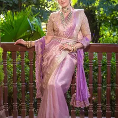 The elegance of this look is in its balance. The intricate gold blouse and emerald jewelry are the heroes, supported by soft, luminous makeup.