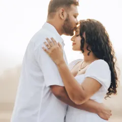 An intimate golden hour portrait of Janice and Lyle. The warm backlighting highlights their connection and creates a soft, romantic glow.