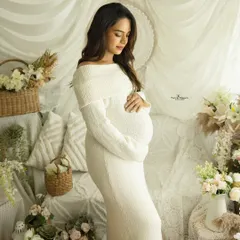 A serene and gentle solo maternity portrait in our all-white boho studio setup. The soft lighting and natural textures create a peaceful and angelic atmosphere, perfectly highlighting the pregnancy glow.