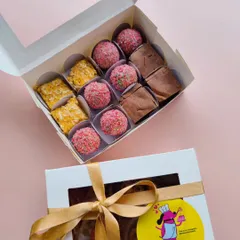 A close-up of my 'Simba's Mithai Box' for Diwali. It contains an assortment of laddoo truffles, brownie barfis, and pumpkin coconut barfis, all made with dog-safe ingredients.