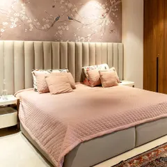 We designed this master bedroom to be a true sanctuary. The blush-toned bedding and vertically channeled headboard create a soft, inviting feel, while the bespoke cherry blossom wall mural adds a touch of serene, artistic elegance. It’s a space crafted not just for rest, but for complete restoration.