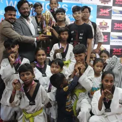 A proud moment for my team from the Warrior Fight Club after a successful championship. You can see the joy and sense of accomplishment as the students hold up their trophy and show off their hard-earned medals. This is the result of their dedication and hard work.