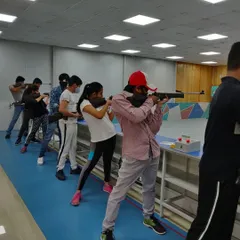 A full line of shooters during a friendly match at our academy. These events are a great way for beginners to experience a simulated competition environment.