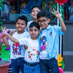 A group of smiling boys posing for a photo during our Holi celebration, dressed in festive attire and ready for a day of color and fun.