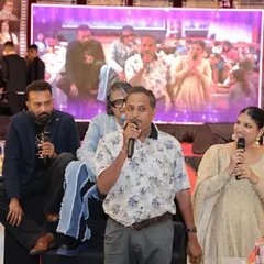 Sharing the mic with a family member on stage. It's moments like these, where guests become part of the show, that are truly memorable.