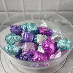 A bowl full of my homemade chocolates, wrapped in shiny purple, silver, and teal foil. These are great for filling up candy jars or adding to gift hampers.